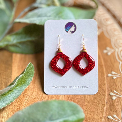 Handmade Christmas earrings in sparkling red, featuring a unique geometric design, perfect for festive celebrations.