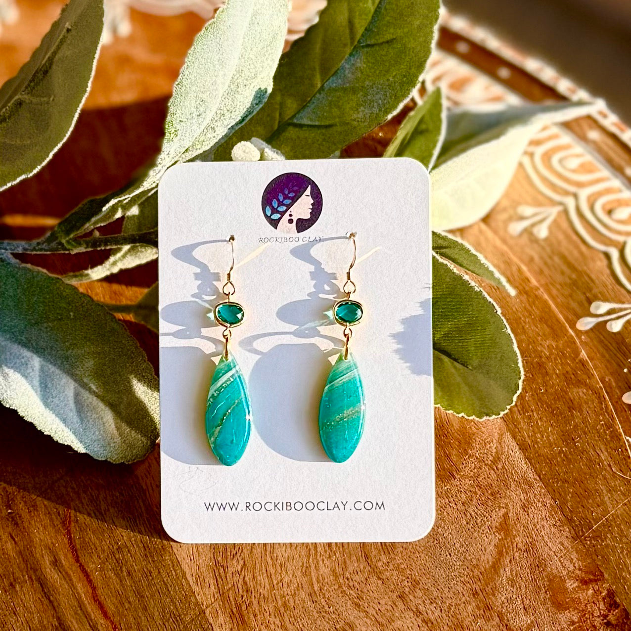 Local handmade hypoallergenic polymer clay earrings in teal with gold-filled settings, showcasing unique designs.
